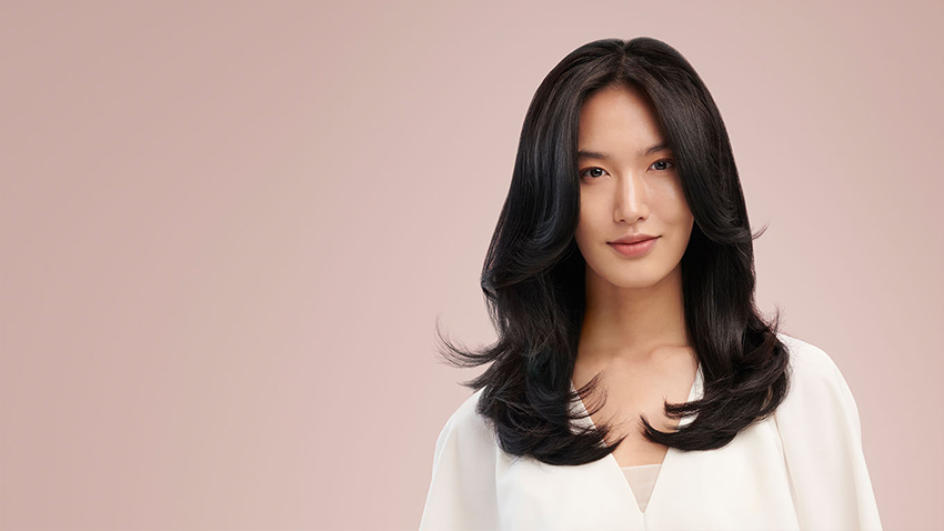 Model wearing smooth c-curl style