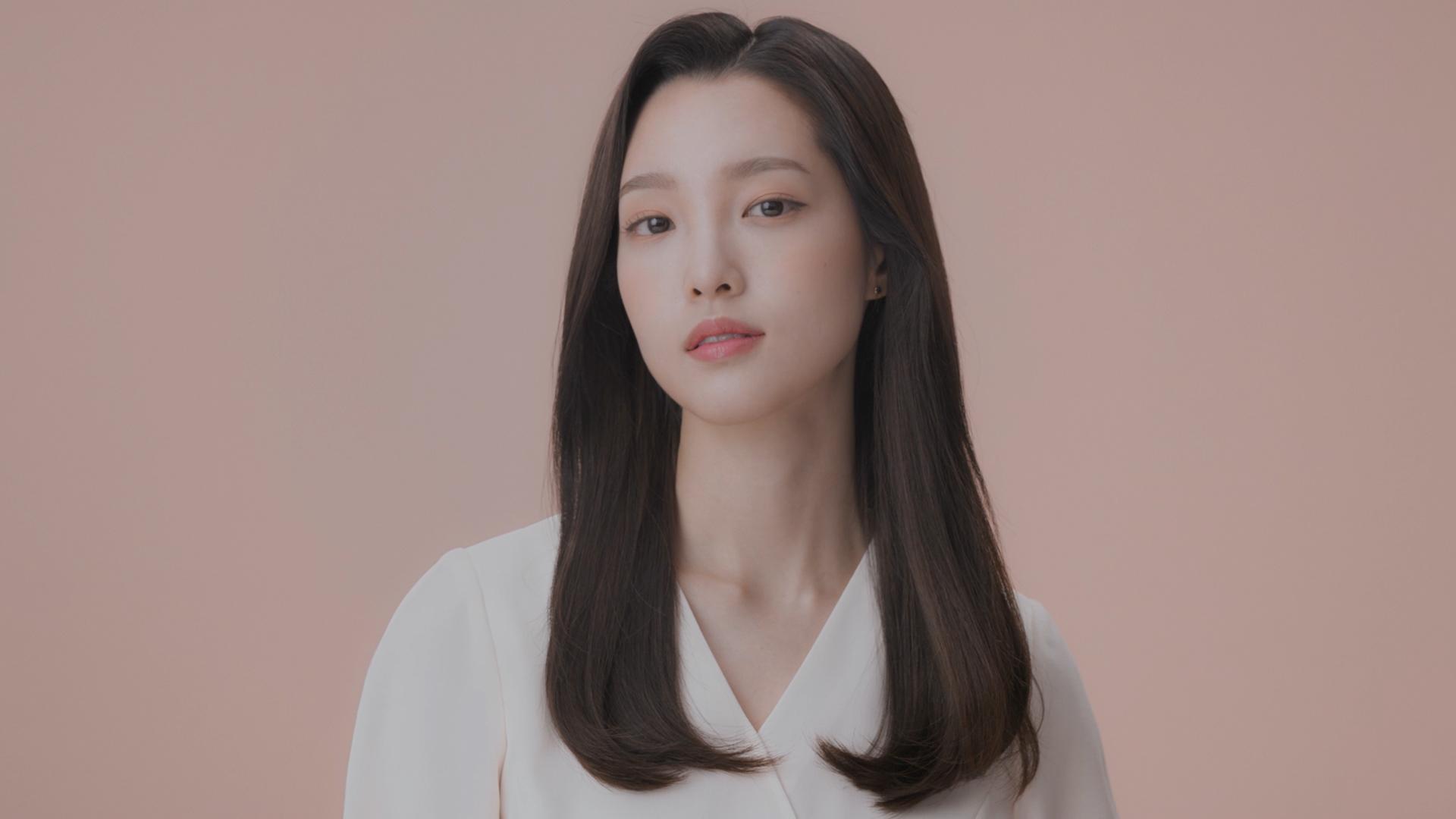 Model wearing a sleek side part style