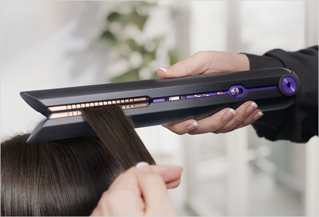 Close up of hair being gathered by the flexing plates on the Dyson Corrale hair straightener