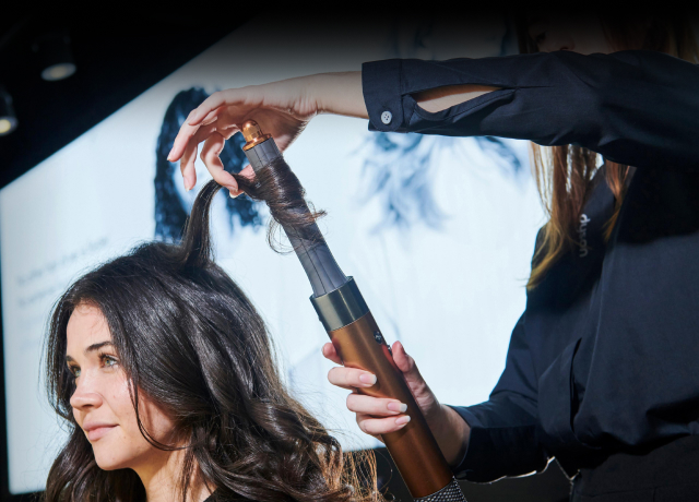 Model curls her hair with Dyson Airwrap multi styler
